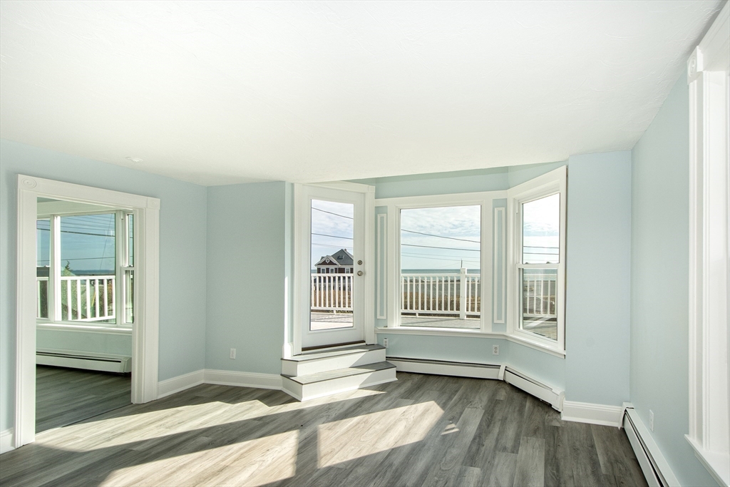 7 Whitehead Avenue, Unit 1 Hull, MA 02045 - Photo 16 of 32 a view of an empty room with glass door and windows