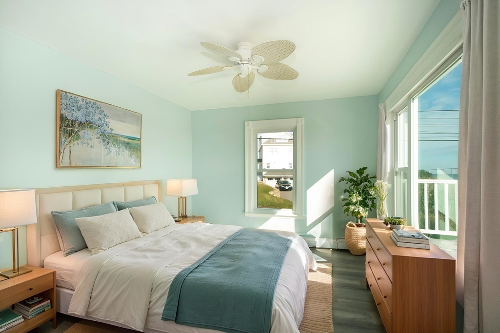 7 Whitehead Avenue, Unit 1 Hull, MA 02045 - Photo 23 of 32 a bed room with a bed and a chandelier