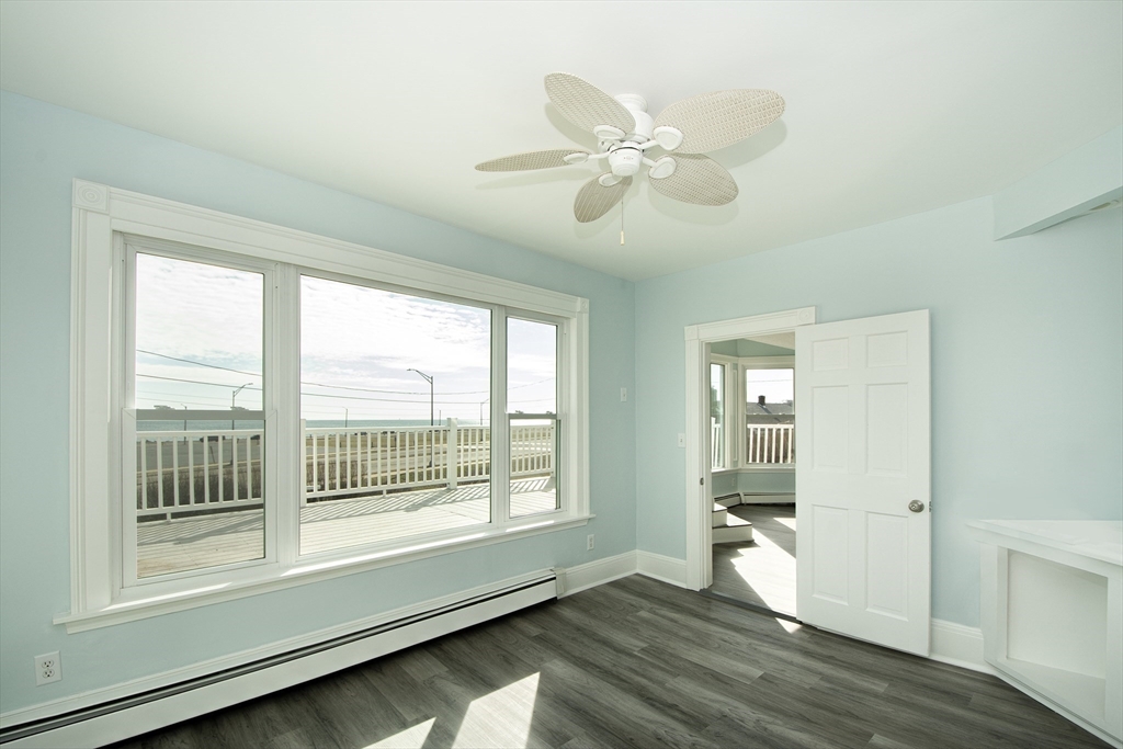 7 Whitehead Avenue, Unit 1 Hull, MA 02045 - Photo 25 of 32 a view of an empty room with wooden floor and a window