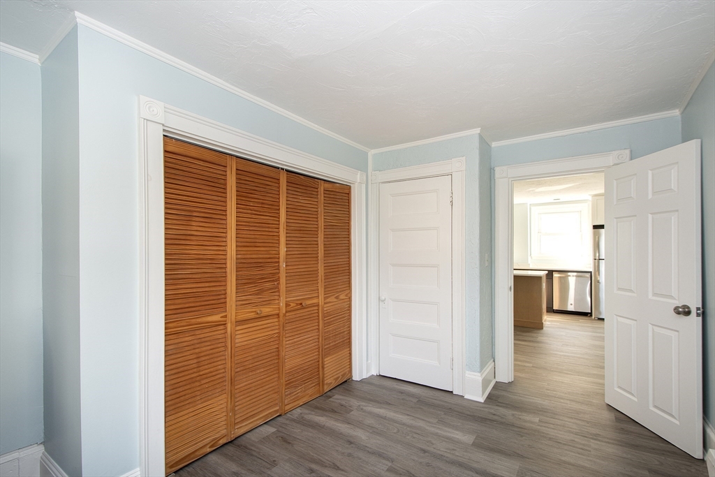 7 Whitehead Avenue, Unit 1 Hull, MA 02045 - Photo 28 of 32 a view of empty room with wooden floor and window