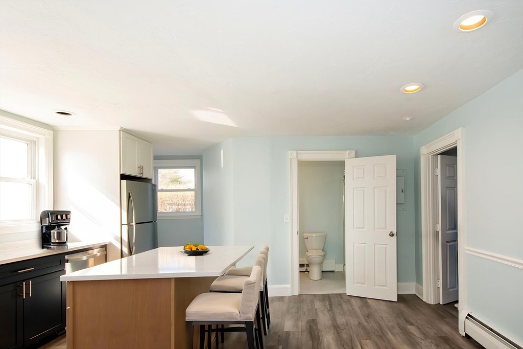 7 Whitehead Avenue, Unit 1 Hull, MA 02045 - Photo 5 of 32 a room with a table chairs and wooden floor