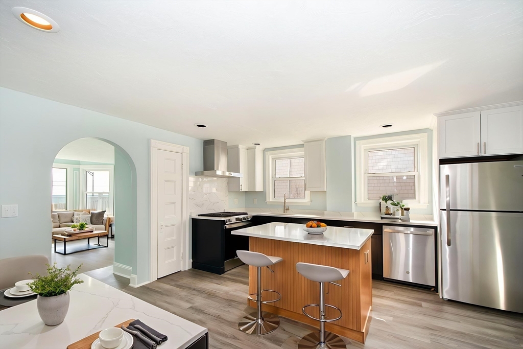 7 Whitehead Avenue, Unit 1 Hull, MA 02045 - Photo 9 of 32 a kitchen with a sink appliances and cabinets