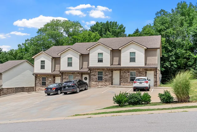a car parked in front of a white house