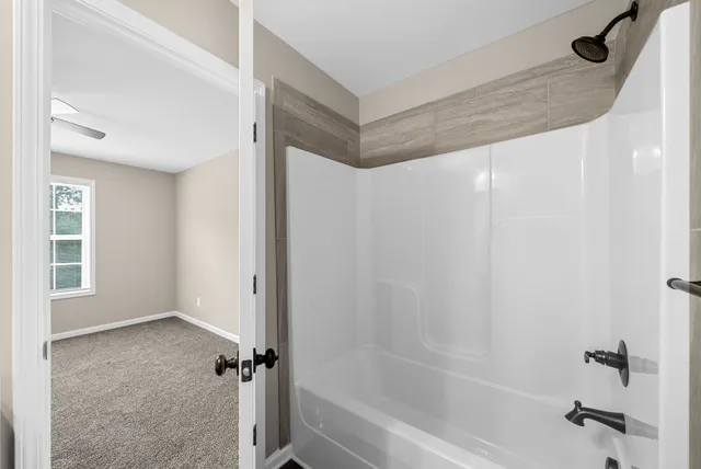 a bathroom with a shower and a bath tub
