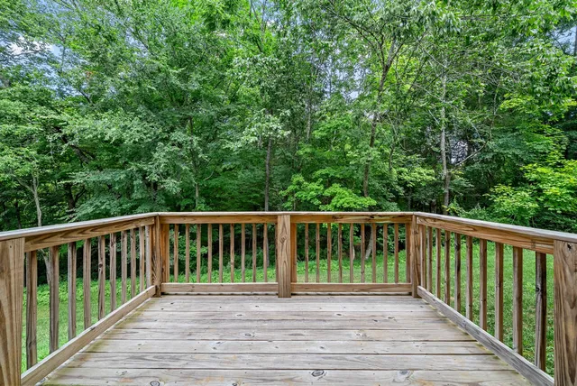 a balcony with view of trees in the background