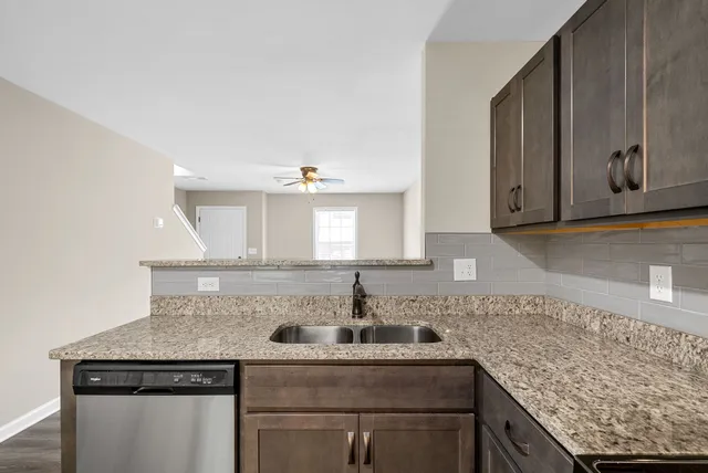 a kitchen with stainless steel appliances granite countertop a sink and cabinets