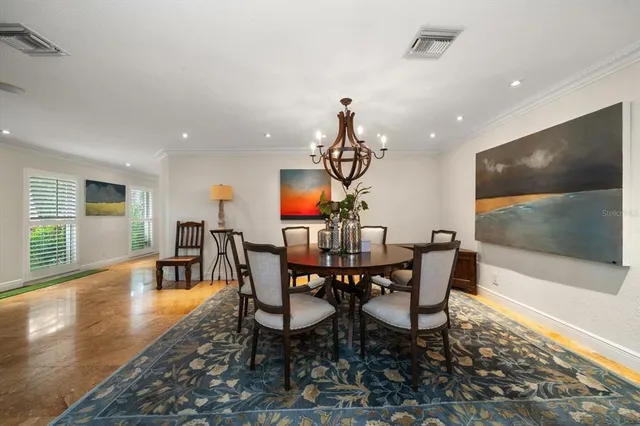 a large kitchen with lots of counter space dining table and stainless steel appliances