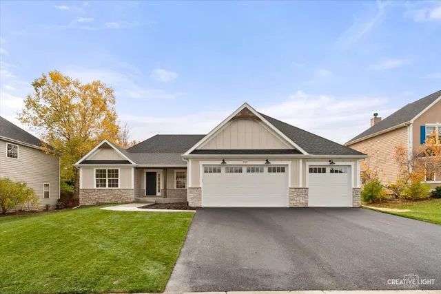 a view of a house with a big yard and large tree