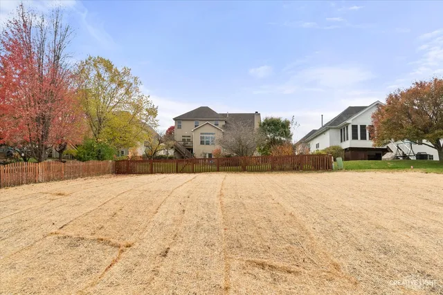 a front view of house with yard and trees around