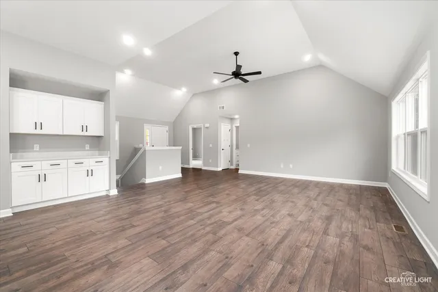 a view of a kitchen with a microwave and wooden floor