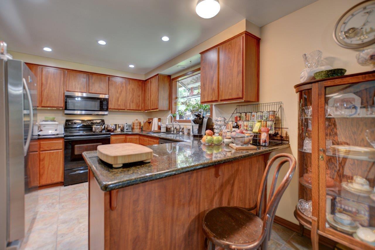 8684 Wagner Creek Road Talent, OR 97540 - Photo 56 of 78 a kitchen with granite countertop a sink stove and refrigerator