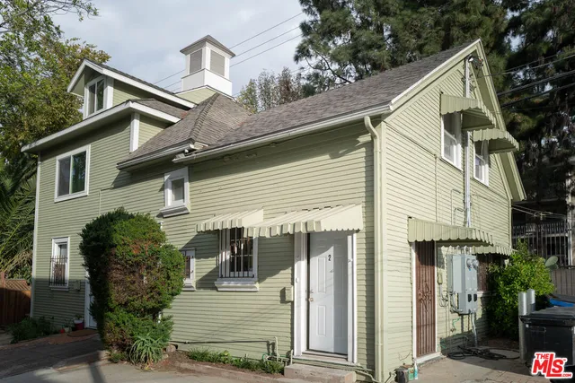 a view of a house with a yard and plants