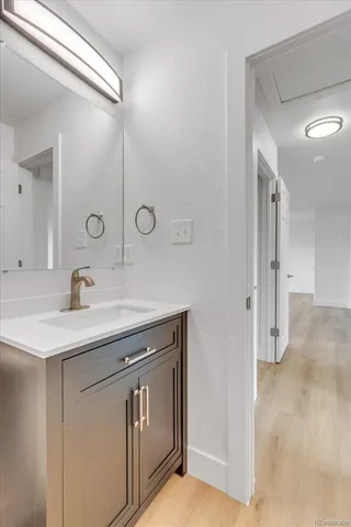 an empty room with a painting on the wall