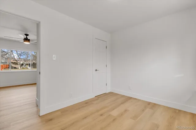 a bathroom with a granite countertop sink a mirror and shower