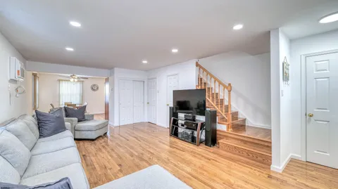 a living room with furniture and a wooden floor