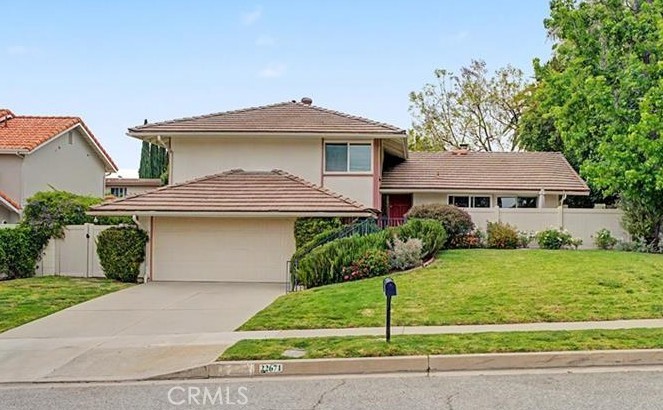 22671 Town Crier Road Calabasas, CA 91302 - Photo 2 of 35 a front view of a house with a garden