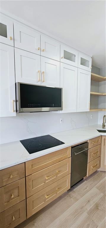 a kitchen with white cabinets and a microwave oven