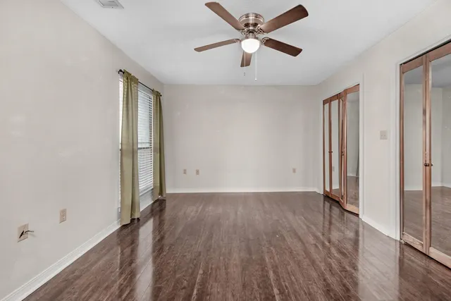 wooden floor in an empty room with a window