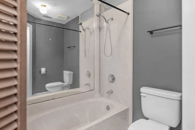 a bathroom with a toilet and shower