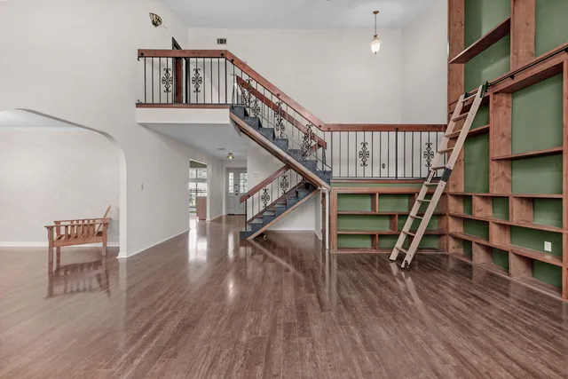 a view of entryway and hall with wooden floor