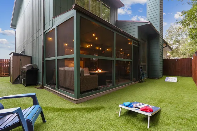 a backyard of a house with yard and furniture