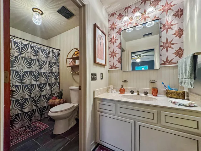 a bathroom with a sink toilet and shower