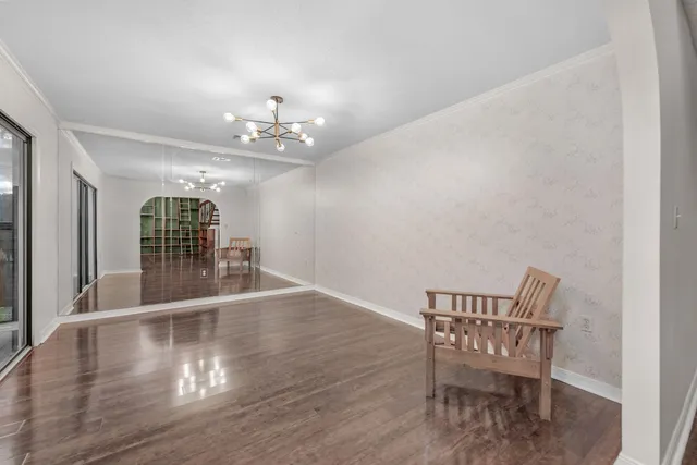a view of a livingroom with wooden floor and a ceiling fan