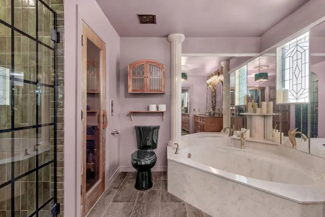 a bathroom with a tub and shower