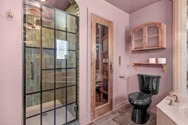 a bathroom with a sink toilet and shower