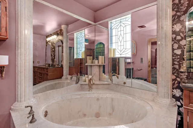 a bathroom with a tub sink and mirror