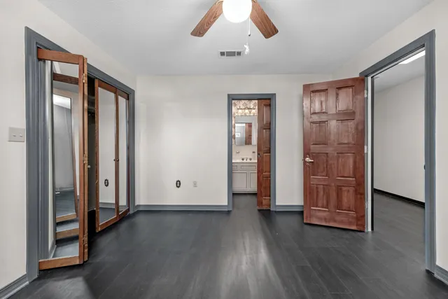 an empty room with wooden floor and closet