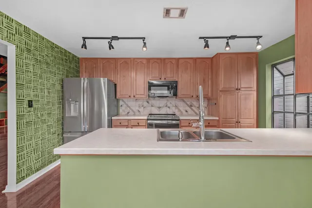 a kitchen with a table chairs and refrigerator