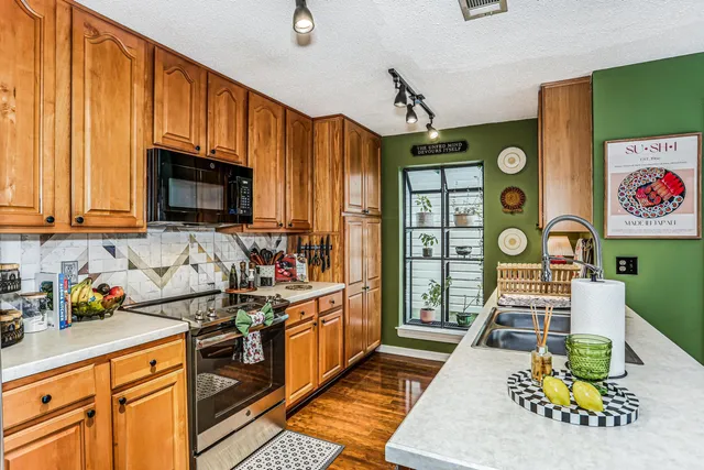 a kitchen that has a lot of cabinets in it