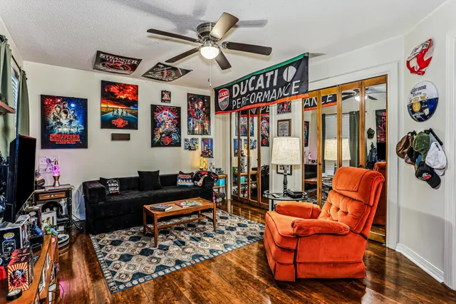 a living room with furniture a rug and a chandelier