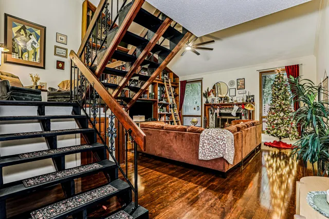 a living room with furniture and a book shelf