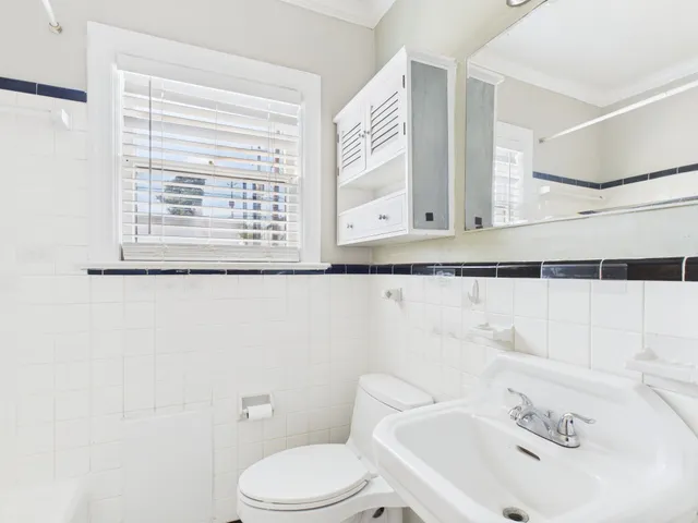 a bathroom with a sink a mirror and a toilet