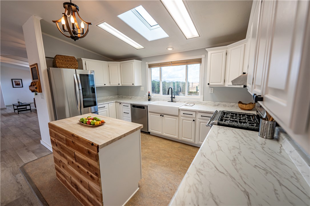 2765 North Silver Springs Road Kingman, AZ 86401 - Photo 30 of 60 a kitchen with a stove a sink and a refrigerator