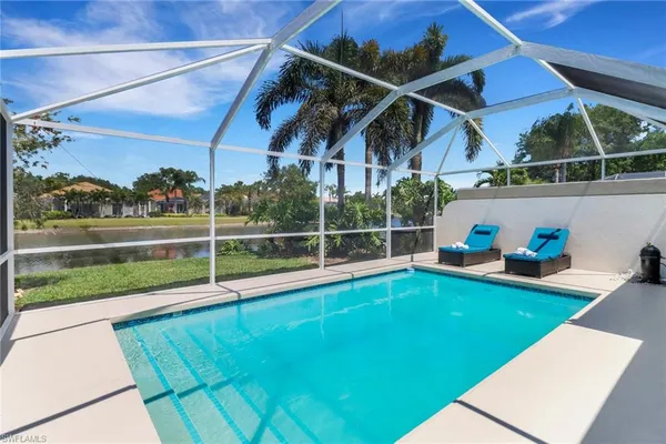 a view of a backyard with table and chairs
