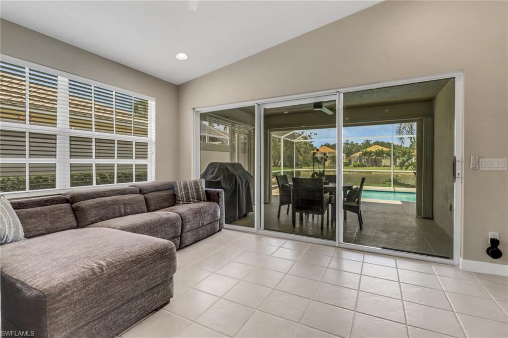 5365 Guadeloupe Way Naples, FL 34119 - Photo 17 of 47 a living room with furniture and large windows
