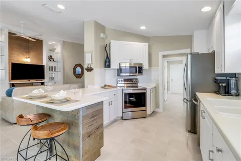 a kitchen with stainless steel appliances a stove refrigerator sink and microwave