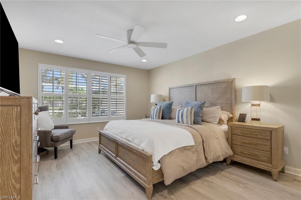 5365 Guadeloupe Way Naples, FL 34119 - Photo 21 of 47 a bedroom with a bed and a chandelier