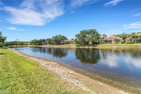 a view of a lake with houses in the back