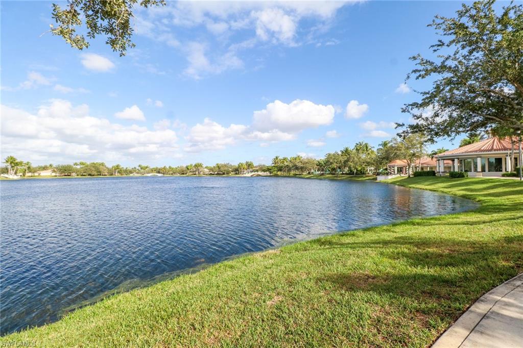 5365 Guadeloupe Way Naples, FL 34119 - Photo 38 of 47 a view of a lake with houses in the back