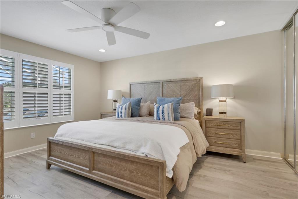 5365 Guadeloupe Way Naples, FL 34119 - Photo 4 of 47 a bedroom with a bed and a ceiling fan