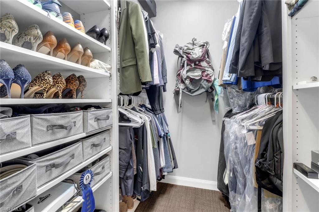 5365 Guadeloupe Way Naples, FL 34119 - Photo 10 of 47 a view of walk in closet with clothes and shoes