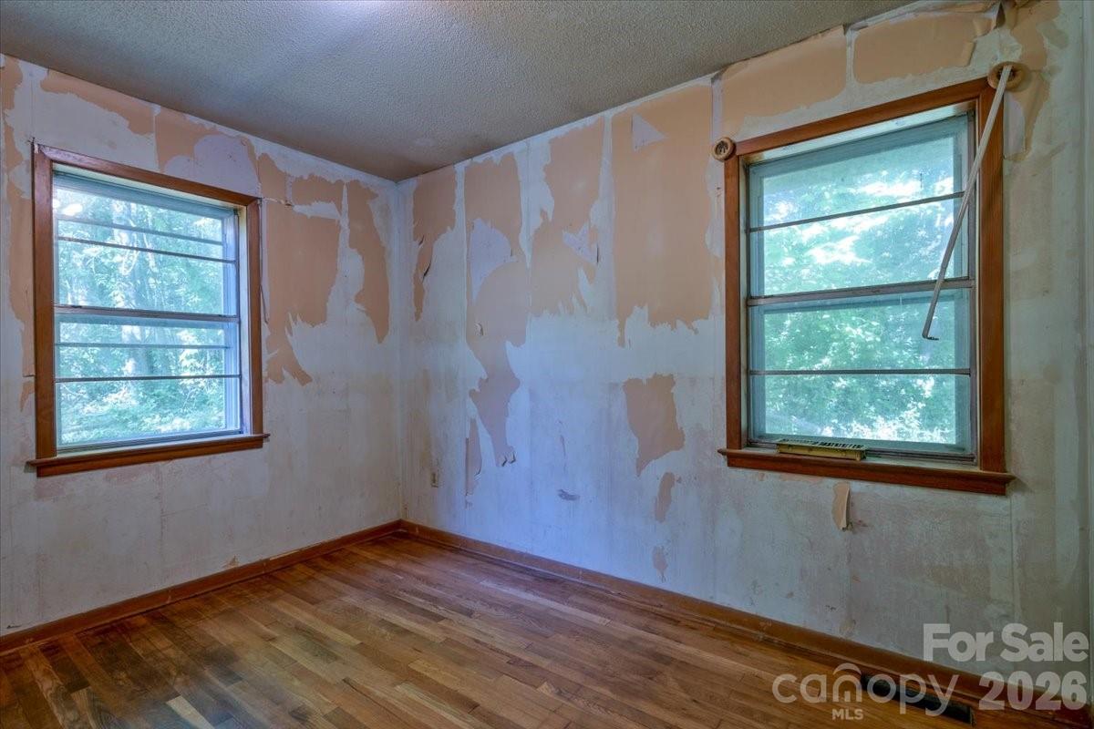 156 Old Sweetwater Road Robbinsville, NC 28771 - Photo 20 of 25 a view of an empty room with wooden floor and a window