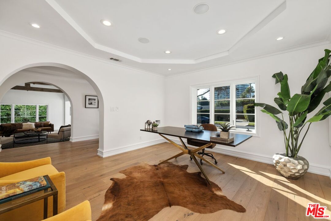 514 Walden Drive Beverly Hills, CA 90210 - Photo 17 of 59 a living room with furniture gym and a potted plant
