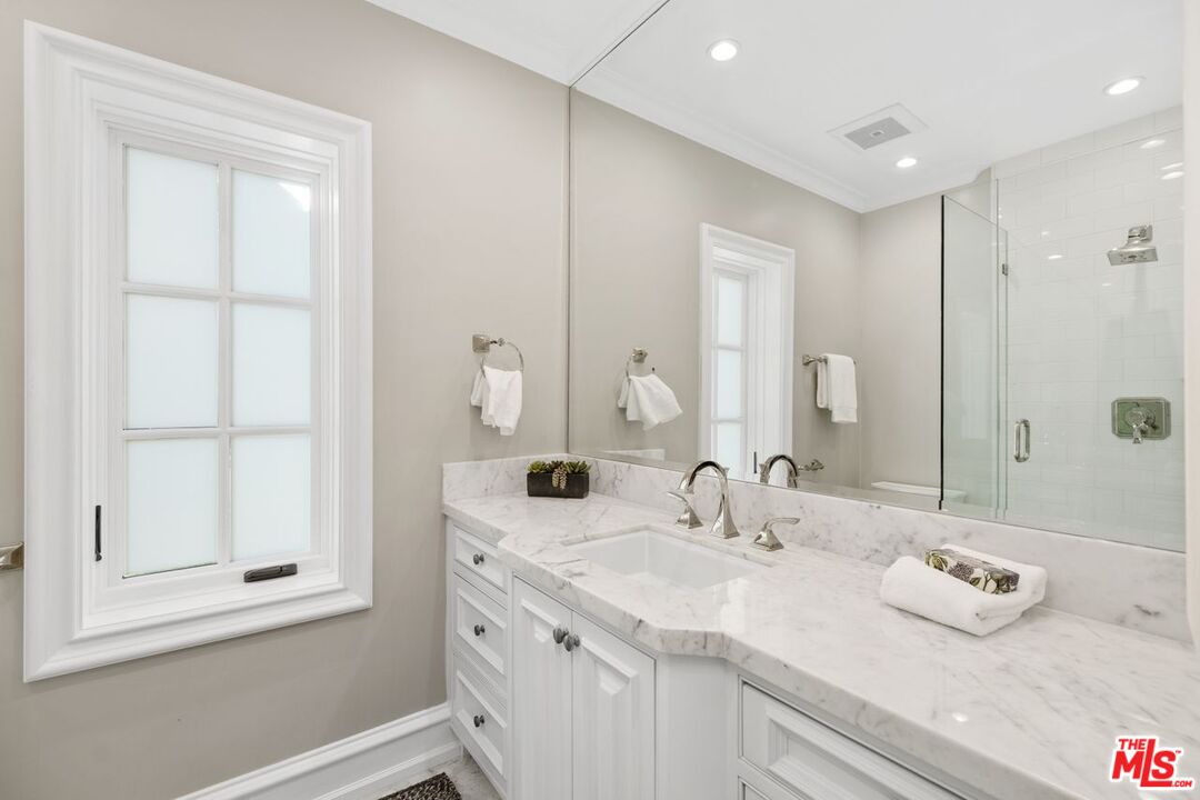 514 Walden Drive Beverly Hills, CA 90210 - Photo 18 of 59 a bathroom with a granite countertop sink and a mirror