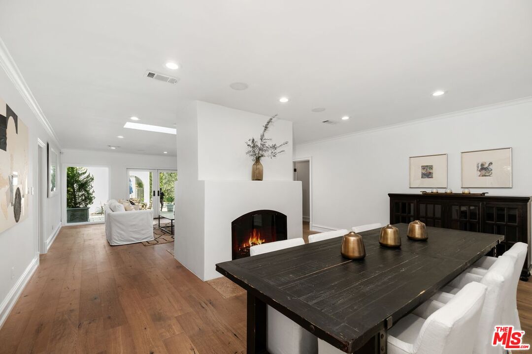 514 Walden Drive Beverly Hills, CA 90210 - Photo 21 of 59 a view of a dining room with furniture and wooden floor