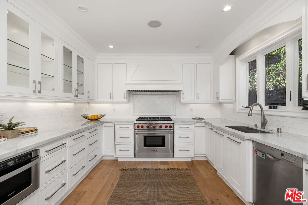 514 Walden Drive Beverly Hills, CA 90210 - Photo 23 of 59 a kitchen with stainless steel appliances granite countertop a stove sink and cabinets